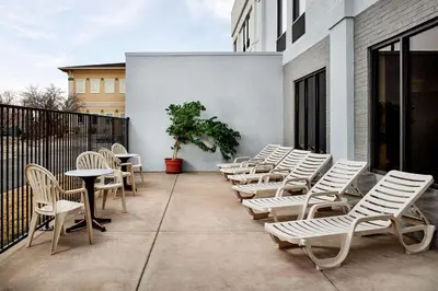 a row of chairs and tables on a patio at Hampton Inn Longmont in Longmont