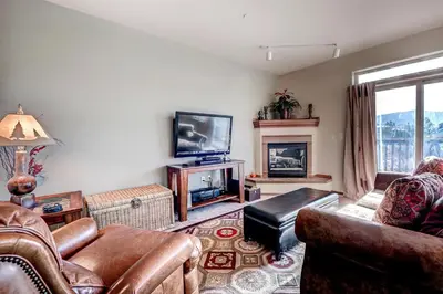 a living room with a couch and a tv at Tarn Landing C-19 Condo in Frisco