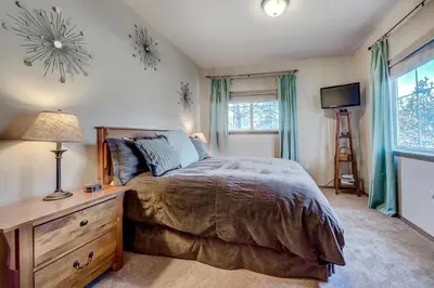a bedroom with a bed and a dresser and a television at Tarn Landing C-19 Condo in Frisco