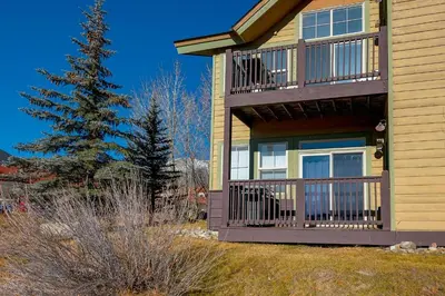 a house with a large deck on the side of it at Tarn Landing C-19 Condo in Frisco