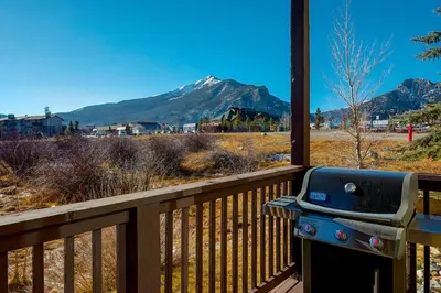 a grill on a porch with a view of a mountain at Tarn Landing C-19 Condo in Frisco
