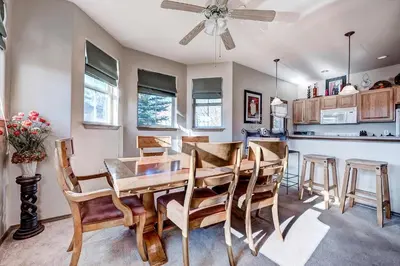 a kitchen and dining room with a table and chairs at Tarn Landing C-19 Condo in Frisco