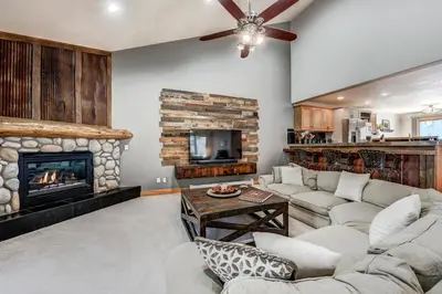 a living room with a couch and a fireplace at Streamside 333B Townhouse in Frisco