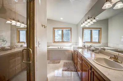 a bathroom with two sinks and a tub at Streamside 333B Townhouse in Frisco