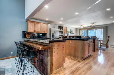 a large kitchen with wooden cabinets and a large island at Streamside 333B Townhouse in Frisco