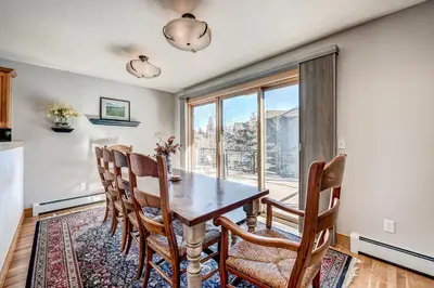 a dining room with a table and chairs and a window at Streamside 333B Townhouse in Frisco