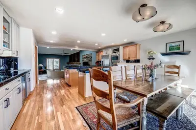 a kitchen with a wooden table and a dining room at Streamside 333B Townhouse in Frisco
