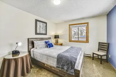 a bedroom with a bed and a table and a chair at Forest Park F Condo in Frisco