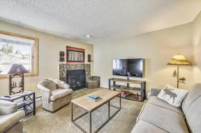 a living room with couches and a fireplace at Forest Park F Condo in Frisco