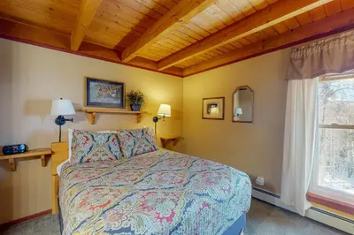 a bedroom with a bed and a window at Treehouse 202 in Silverthorne
