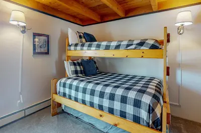 a bedroom with two bunk beds in a cabin at Treehouse 202 in Silverthorne