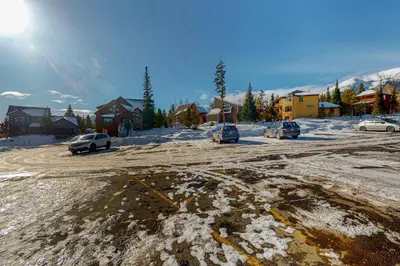 a parking lot with cars parked in the snow at Treehouse 202 in Silverthorne