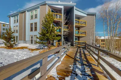 a building with a wooden walkway in front of a building at Treehouse 202 in Silverthorne