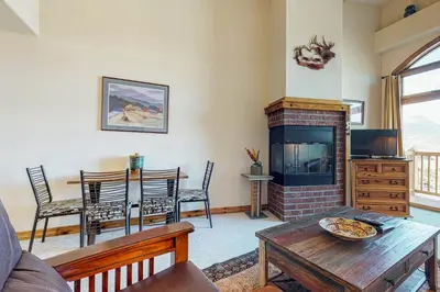 a living room with a table and a fireplace at Dillon Commons Studio in Dillon