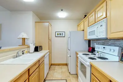 a kitchen with a sink and a white refrigerator at Dillon Commons Studio in Dillon