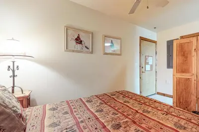 a bedroom with a bed and two pictures on the wall at Dillon Commons Studio in Dillon