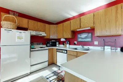 a kitchen with white appliances and wooden cabinets at Buffalo Ridge 205 in Silverthorne