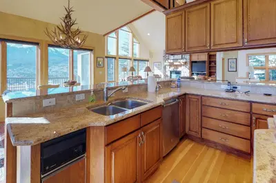 a large kitchen with wooden cabinets and a sink at Aspen View in Silverthorne