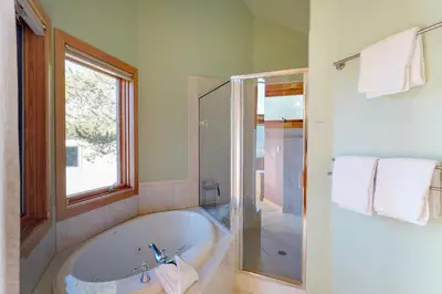 a bathroom with a bath tub and a window at Aspen View in Silverthorne