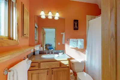 a bathroom with a sink and a toilet and a mirror at Aspen View in Silverthorne