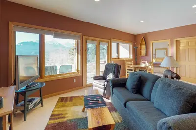 a living room with a blue couch and a table at Aspen View in Silverthorne