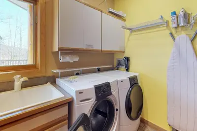 a laundry room with a washing machine and a sink at Aspen View in Silverthorne