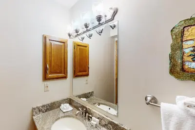 a bathroom with a sink and a mirror at Buffalo Village 402 in Silverthorne