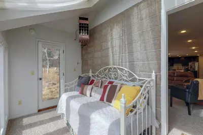 a bedroom with a white bed with pillows at Alpine Getaway in Gold Hill