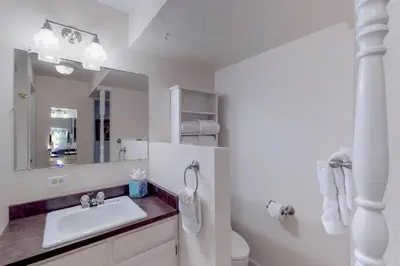 a white bathroom with a sink and a mirror at Alpine Getaway in Gold Hill
