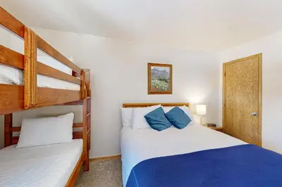 two beds in a room with two bunk beds at Buffalo Village 306 in Silverthorne