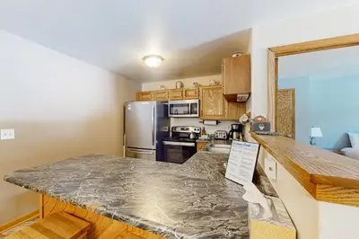 a kitchen with a large counter top in a room at Buffalo Village 306 in Silverthorne