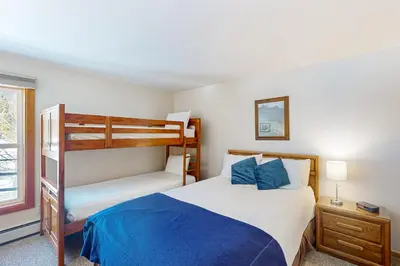 a bedroom with a bed and a bunk bed at Buffalo Village 306 in Silverthorne