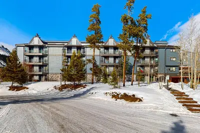 a large building in the snow with a road in front at Buffalo Village 306 in Silverthorne