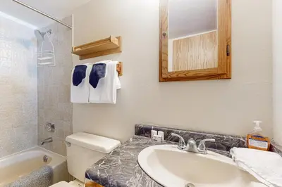 a bathroom with a sink and a toilet and a mirror at Buffalo Village 306 in Silverthorne