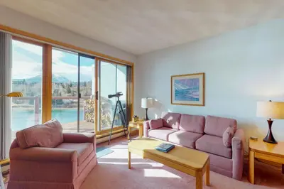 a living room with purple furniture and a large window at East Bay 6 in Dillon