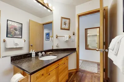 a bathroom with a sink and a mirror at East Bay 6 in Dillon