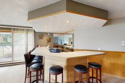 a kitchen with a counter with stools around it at East Bay 6 in Dillon