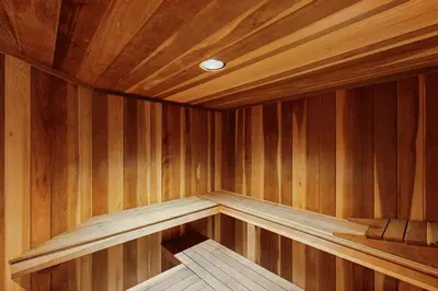 a corner of a wooden sauna with a light in it at East Bay 6 in Dillon
