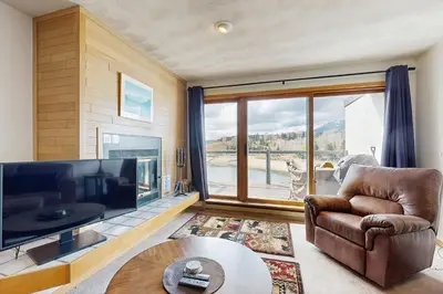 a living room with a large tv and a couch and a table at East Bay 6 in Dillon