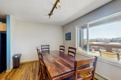 a dining room with a table and chairs and a window at Watch Hill in Silverthorne