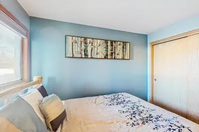 a bedroom with a blue wall with a bed at Watch Hill in Silverthorne
