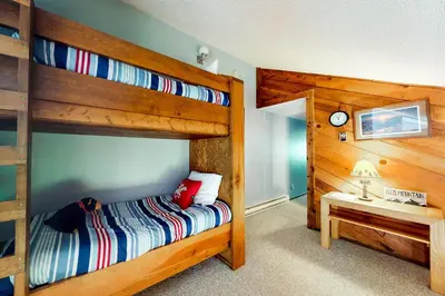 a bedroom with a bunk bed and a desk at Blue River Rendezvous in Silverthorne
