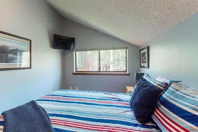 a bedroom with a bed and a window at Blue River Rendezvous in Silverthorne