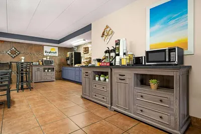 a kitchen with a counter with a microwave at Days Inn by Wyndham Fort Collins in Fort Collins