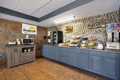 a restaurant with a counter with food on it at Days Inn by Wyndham Fort Collins in Fort Collins
