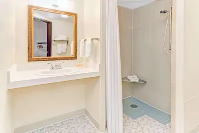 a bathroom with a sink and a shower at Days Inn by Wyndham Fort Collins in Fort Collins
