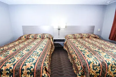 a hotel room with two beds in a room at Belcaro Motel in Denver