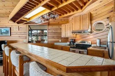 a kitchen with a large wooden table in a cabin at Stutzhaven In The Mountains Home in Estes Park