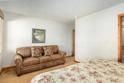 a bedroom with a couch and a bed at Stutzhaven In The Mountains Home in Estes Park
