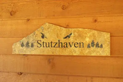 a sign on a wooden wall with birds on it at Stutzhaven In The Mountains Home in Estes Park